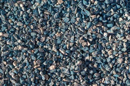 Turquoise gravel, stones two colors - turquoise and gray. Bright construction background for advertising