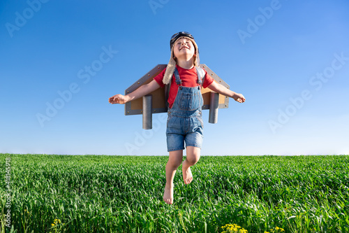 Fototapeta Happy child jumping against blue sky