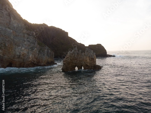 Aerial panorama view of rock formation sea stack natural arch bridge at Playa de Portizuelo Lluarca Asturias Spain photo