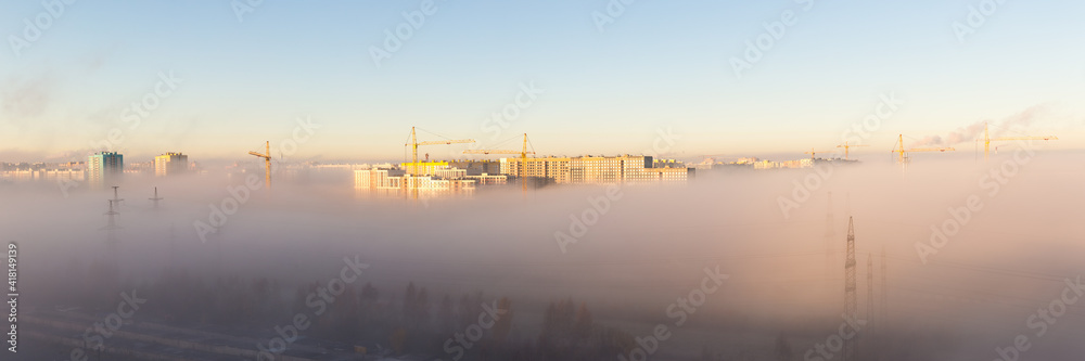 city under the morning fog