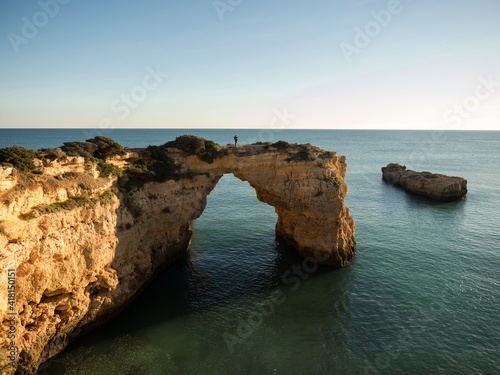 Fotografie, Obraz Panorama view of natural limestone arch bridge Arco de Albandeira beach atlantic