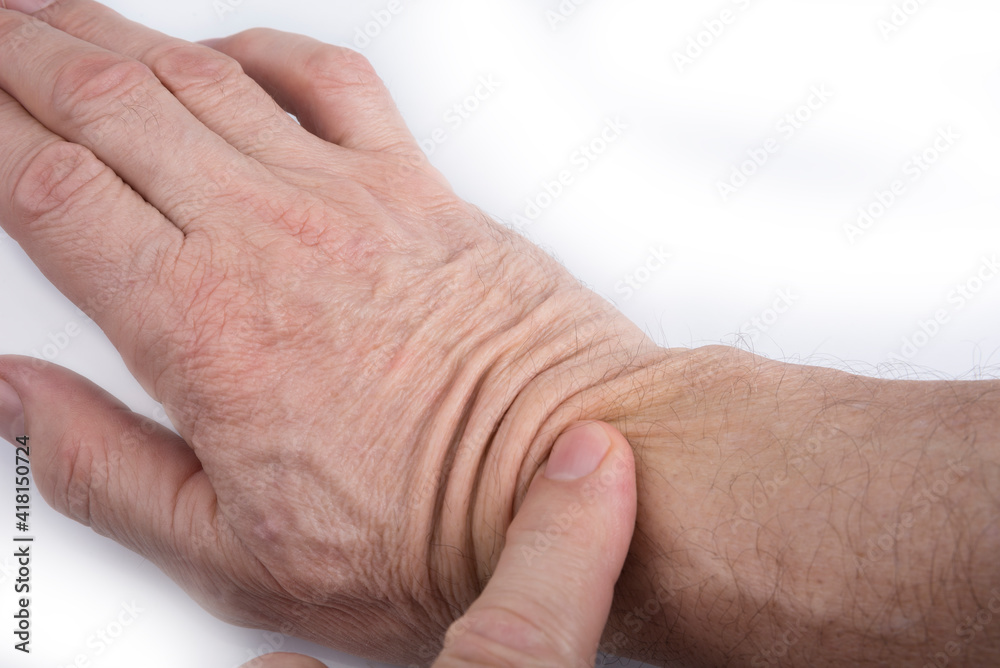 Fototapeta premium Hand 60 years old man with a wrinkled skin on a white