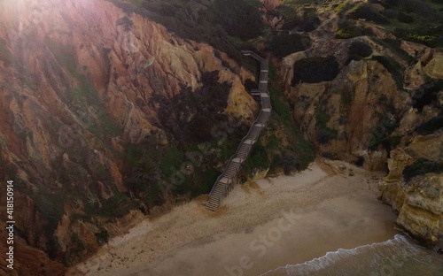 Aerial top down panorama of wooden walkway stairs staircase stairway at Praia do Camilo beach in Lagos Algarve Portugal photo