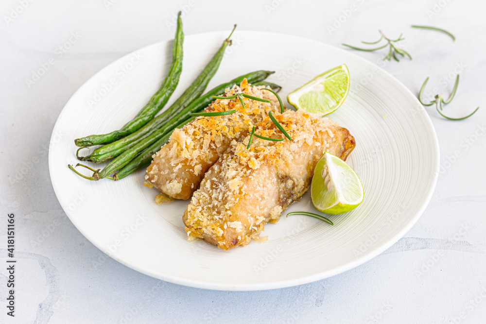 Baked Fish with Green Beans and Lemon Garnished with Rosemary Baked Fish with Green Beans and Lemon Garnished with Rosemary