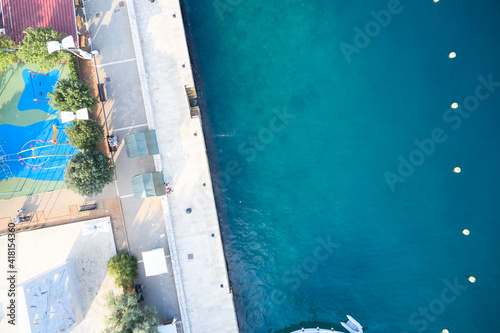 Clean concrete beach with dazzling turquoise water in Croatia. Shooting from a drone.