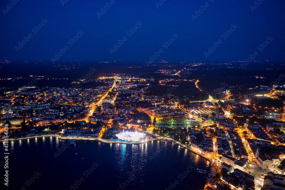 Top view of the night city of Porec in Croatia. Aerial photography.