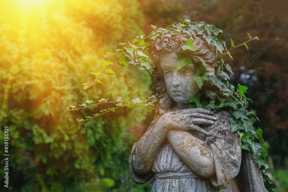 Close up sad angel in prayer. Fragment of an antique destroyed statue.