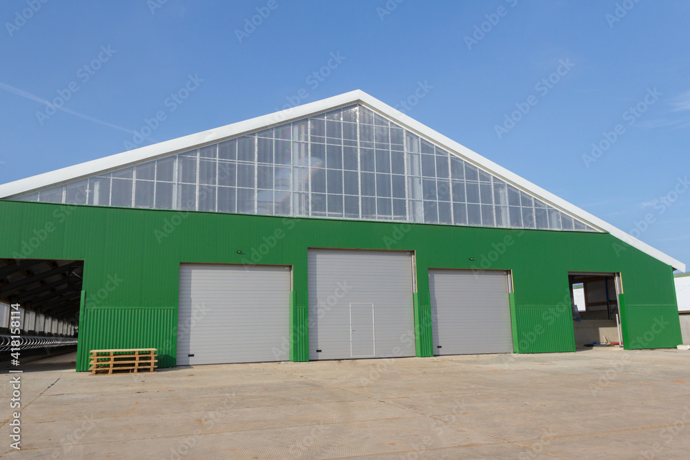 Building under construction with sandwich panel of insulation on the wall. Construction of a new industrial building.