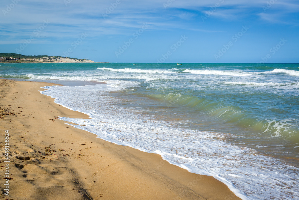 Sea with waves and dunes at Praia do Sagi, Baia Formosa, near Natal, Rio Grande do Norte State, Brazil on January 26, 2021.