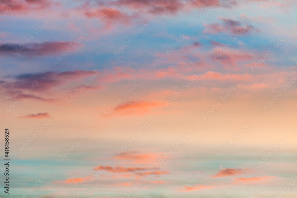 fantastic colorful sky at sunrise with small split clouds