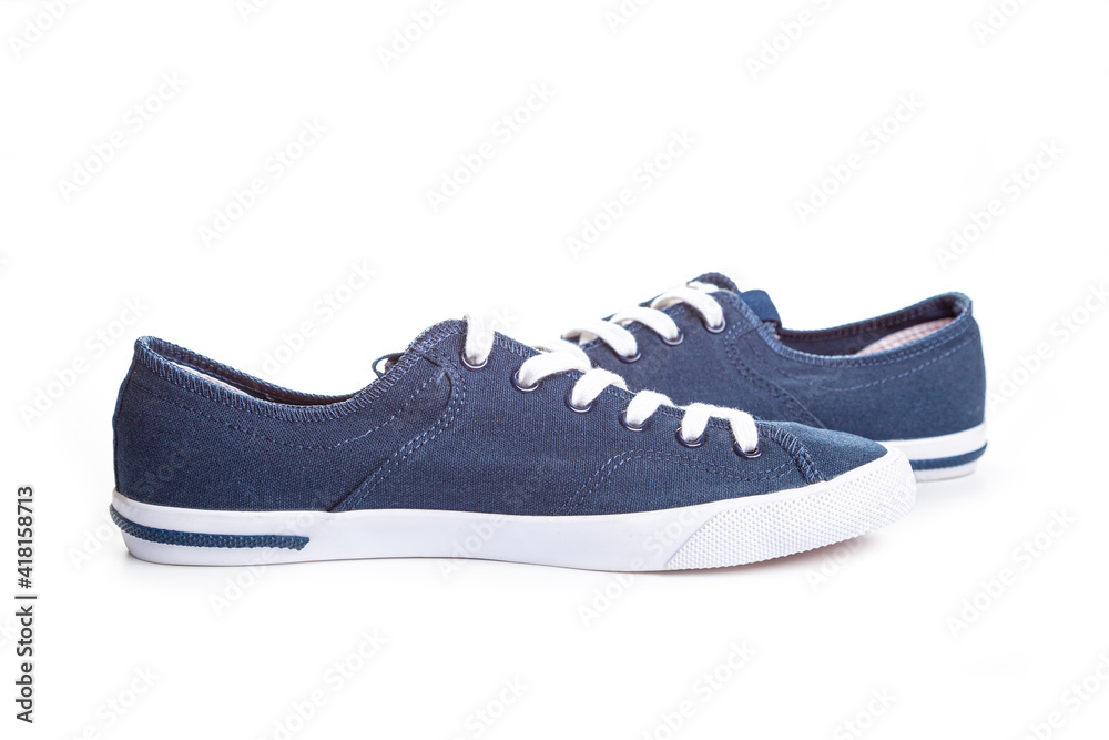 blue sneakers on white background with copy space. Youth shoes.
