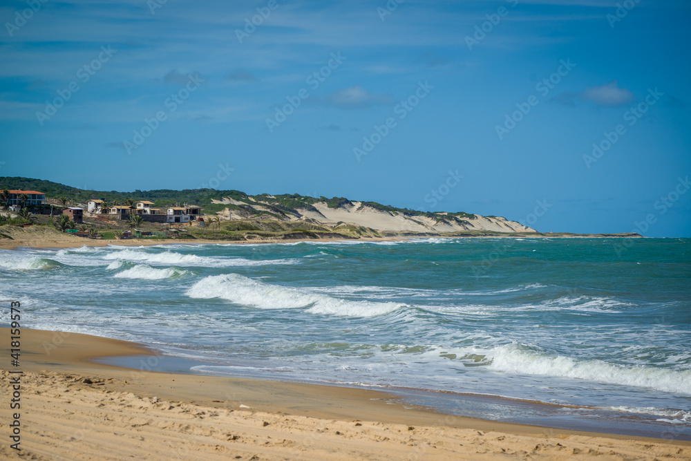 Sea with waves and dunes at  Sagi Beach, Baia Formosa, near Natal, Rio Grande do Norte State, Brazil on January 26, 2021.