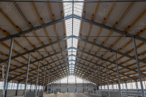 Building frame composition. Steel frame of the building with timber joists and sandwich panels on the roof. Modern construction of industrial buildings. Hangar construction