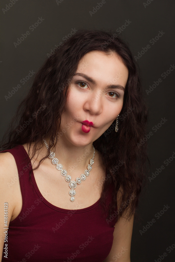 Studio portrait of a brunette in burgundy T-shirt Studio portrait of a brunette in burgundy T-shirt