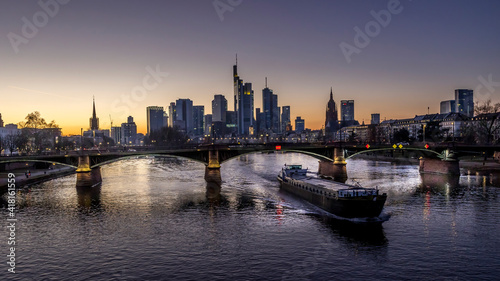The skyline of Frankfurt at sunset  seen from a bridge at the river Main at a cold day in winter.