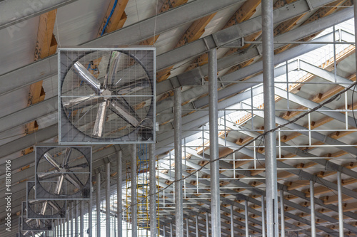 Construction of a complex from a metal frame and sandwich panels. Inside an industrial building. Industrial fans on the roof of the building for blowing off the premises. photo