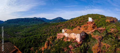 Aerial view of Mare de Deu de la Roca de Mont-roig in Spain, vast hilltop hiking destination with rocky climbing areas, panoramic views and a historic church © alexey_fedoren