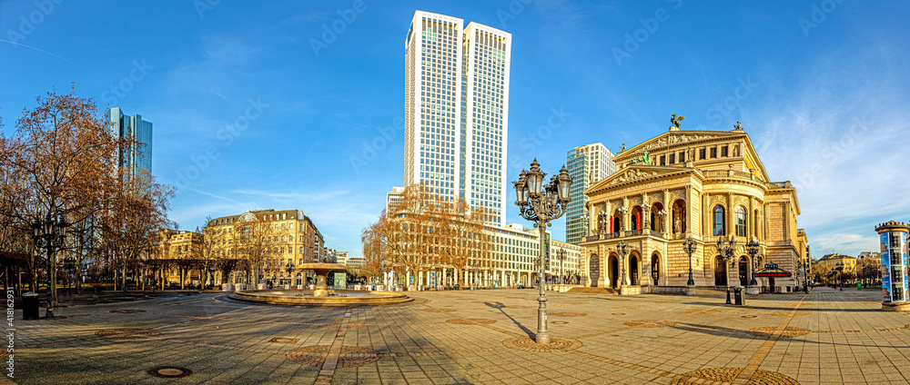 Panoramic view from the Opernplatz in Frankfurt with the historic Alte Oper building over the skyline during sunrise