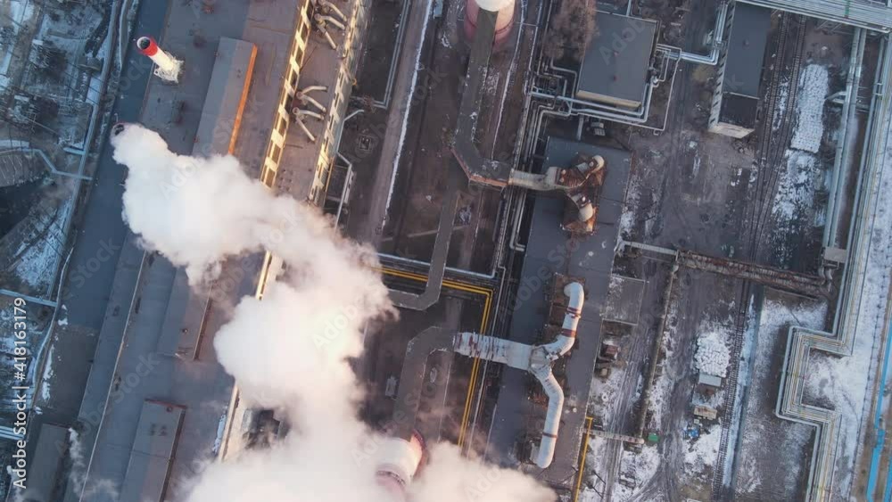Industrial factory pollution atmosphere, smokestack exhaust gases and emission thick smoke. Industry zone. Climate change, global warming and ecology crisis.