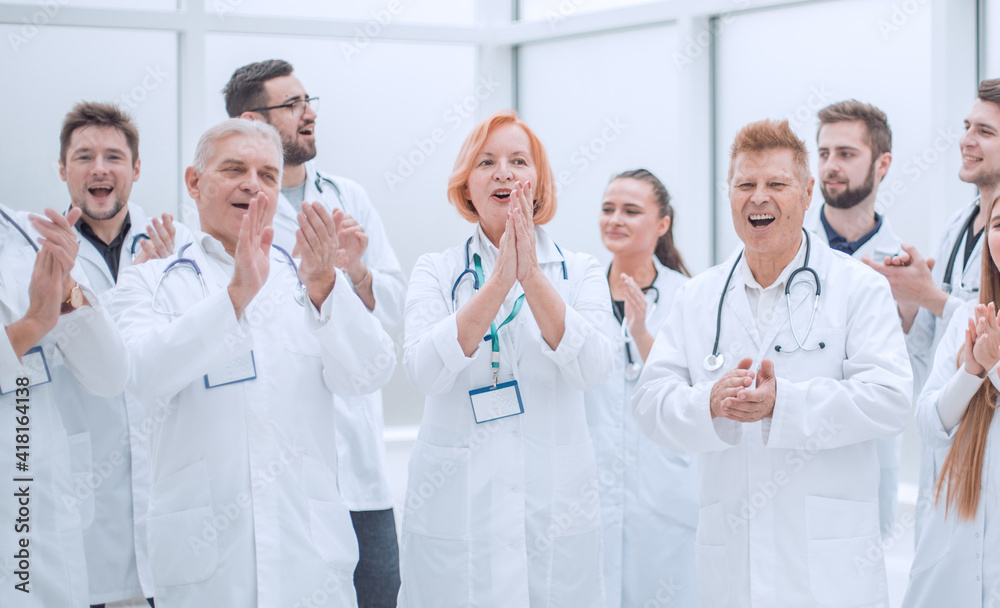group of medical colleagues applauding their overall success. group of medical colleagues applauding their overall success.