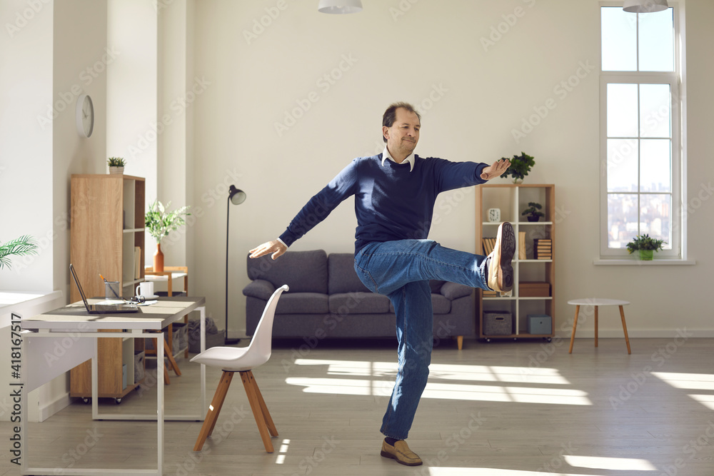 Proper sport activity in home office, workplace fitness concept. Mature freelance worker exercising taking break during working day. Physiotherapy and corrective gymnastics exercises for employee Proper sport activity in home office, workplace fitness concept. Mature freelance worker exercising taking break during working day. Physiotherapy and corrective gymnastics exercises for employee