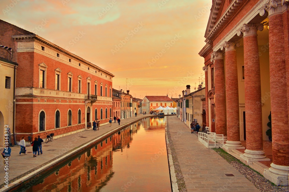 landscape of the characteristic village of Comacchio at sunset time. It is a historic Italian lagoon village also called little Venice, in the province of Ferrara in Emilia Romagna