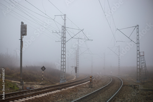 The railway at dawn turns into fog. Autumn atmospheric mood