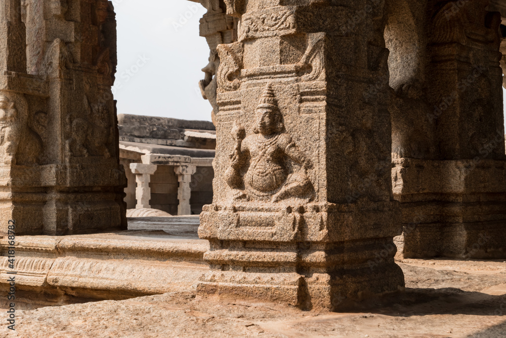 Naklejka premium Examples of ancient architecture. Carving on stone columns in the courtyard of the destroyed Krishna Temple in Hampi, Karnataka, India