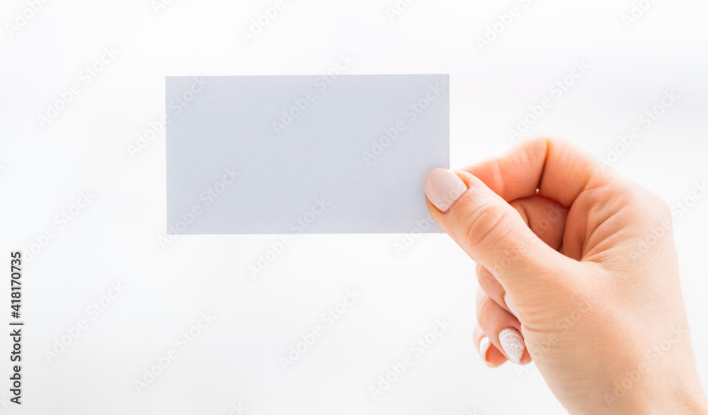 Hand holding empty white business card Hand holding empty white business card