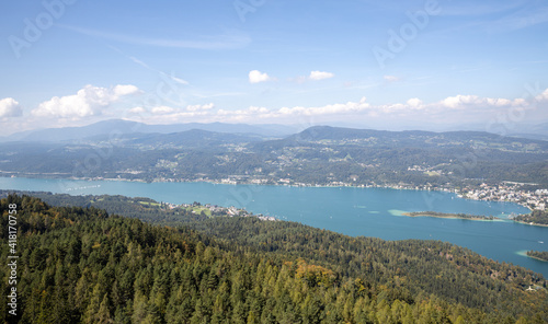 Panoramic top view of the green Austrian Alps, villages and Werthersee lake