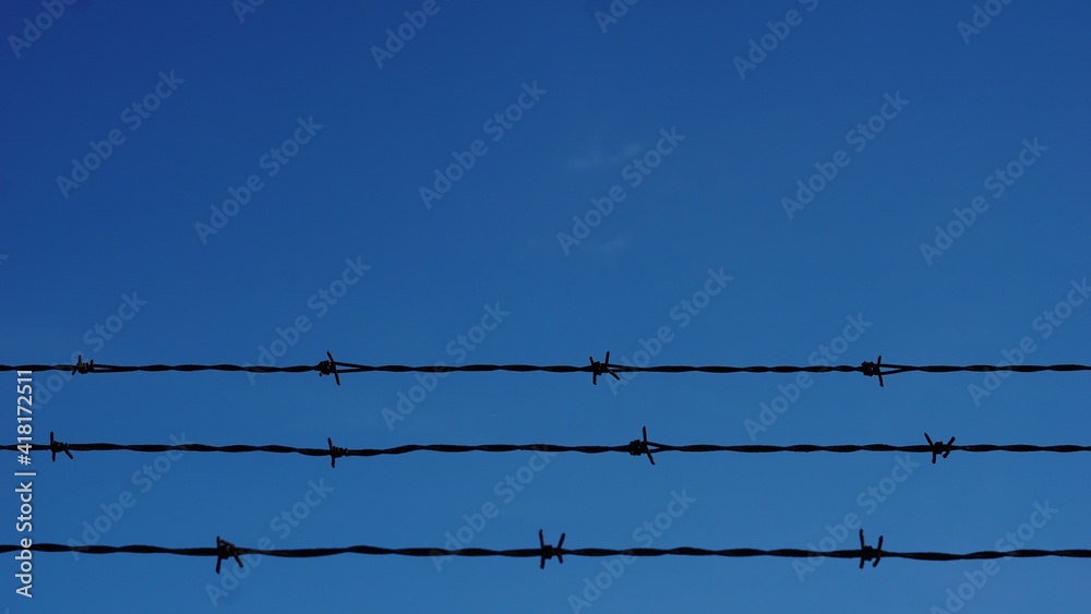 barbed wires against sky background barbed wires against sky background