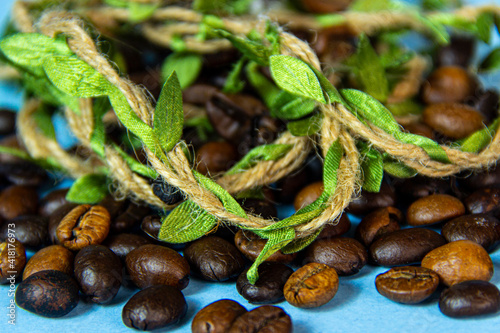 A group of coffee beans with leaves woven from straw. photo