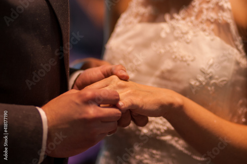 the bride and groom exchange rings. High quality photo