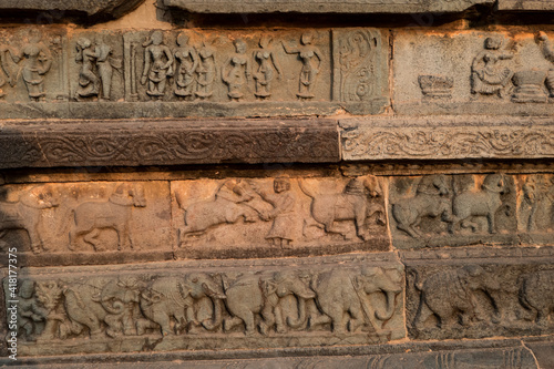 Frescoes on the wall of the ruined royal castle in Hampi, Karnataka, India.  Scenes with animals, people and warriors