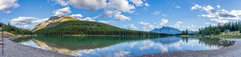 Two Jack Lake panorama view in summer day. Beautiful landscape reflected on water surface. Banff National Park, Canadian Rockies, Alberta, Canada.