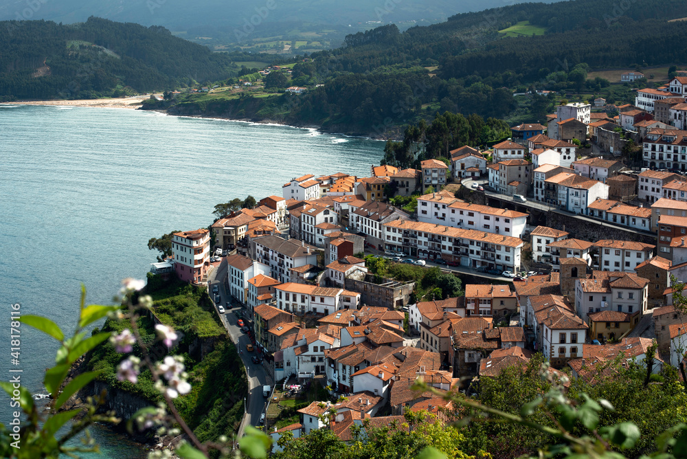 beautiful view of the town of Lastres, Asturias with the Cantabrian coast and the mountains in the background