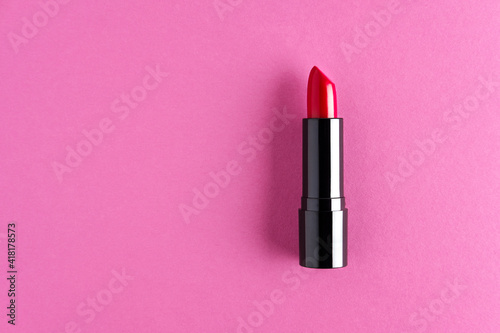 Red lipstick isolated on a fuscia background.