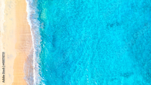 Aerial drone image of beautiful paradise Maldives tropical beach. Ocean seashore with beautiful turquoise water and sea waves. Summer vacation concept.