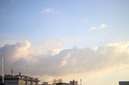 evening clouds over the rooftops of city houses © Artyomtafgai