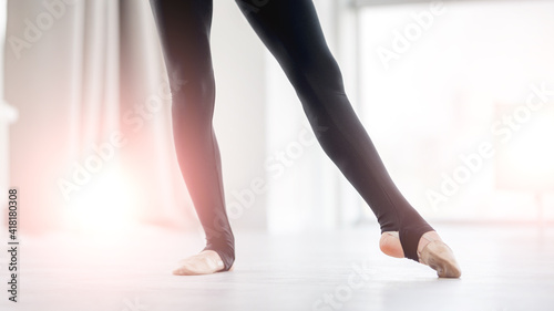 Beautiful ballerina legs during dance class exercices in sunny studio © tan4ikk