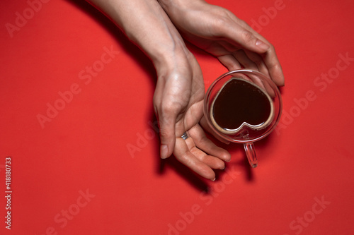 Valentines day hearts background. Woman Holding Hot Cup Of Coffee, With Heart Shape Stock Photo. Beautiful decorative heart shaped on red background, valentines day concept