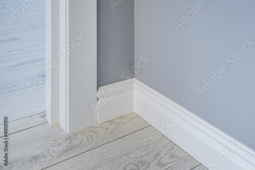 Detail of corner flooring with intricate crown molding and plinth. photo