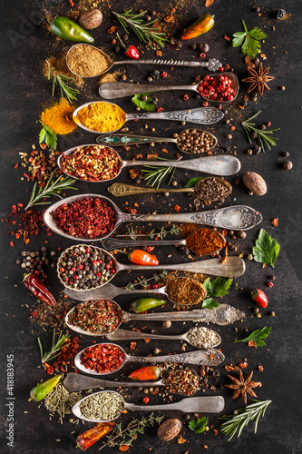 Fototapeta Naklejka Na Ścianę i Meble -  Various spices a vintage spoons on stone table. Colorful Herbal and Spices Oriental marketplace.Top view . Cafe concept. Delicious food delivery.