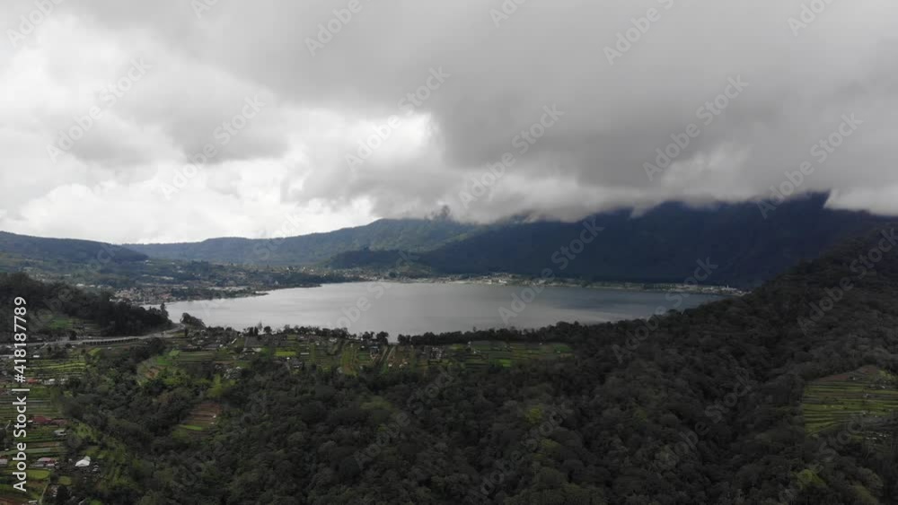 Aerial view, to the mountains and the lake. Caldera lake at Bali. Landscape, lake among mountains, sky, clouds. Aerial footage. Aerial view, to the mountains and the lake. Caldera lake at Bali. Landscape, lake among mountains, sky, clouds. Aerial footage.