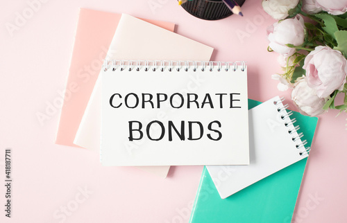 Work smarter text Corporate Bonds on white sheet with pen and notepad.