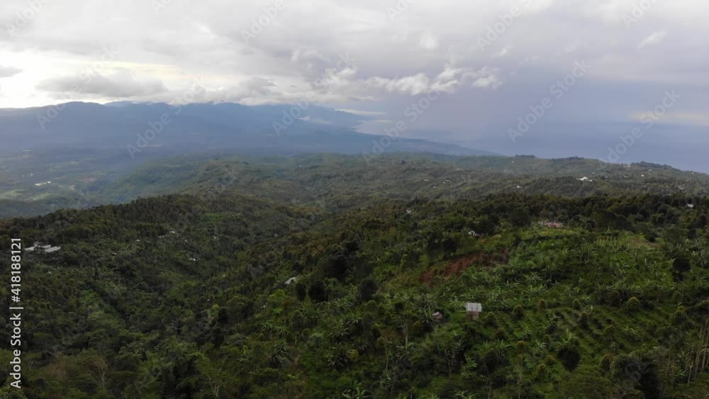 Aerial of flying over a beautiful green forest in a rural landscape mountain hill tropical forrest. Fast shooting by drone view Aerial of flying over a beautiful green forest in a rural landscape mountain hill tropical forrest. Fast shooting by drone view
