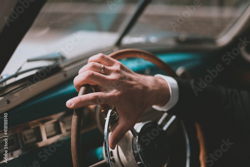 Men's hands on the steering wheel. inside a retro car. Retro style