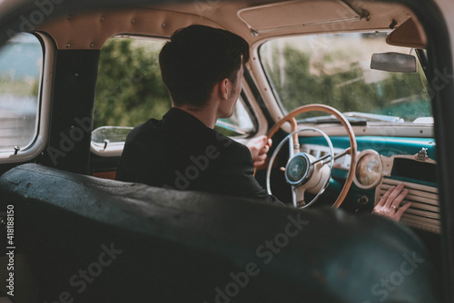 man driving an old car. Retro car salon. Retro photography