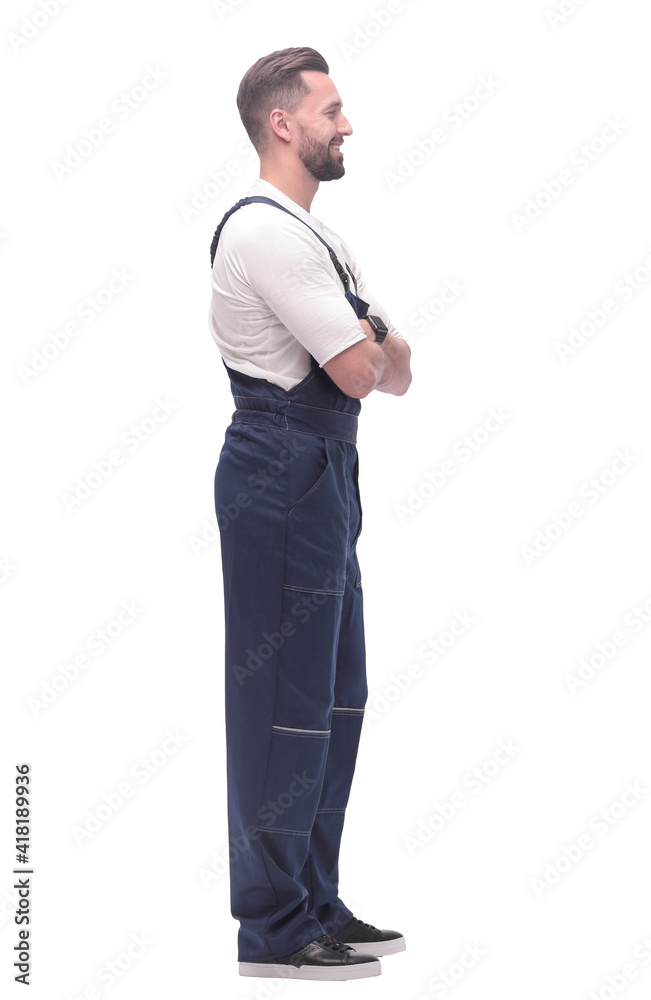 side view. smiling man in overalls looking forward to copy space side view. smiling man in overalls looking forward to copy space