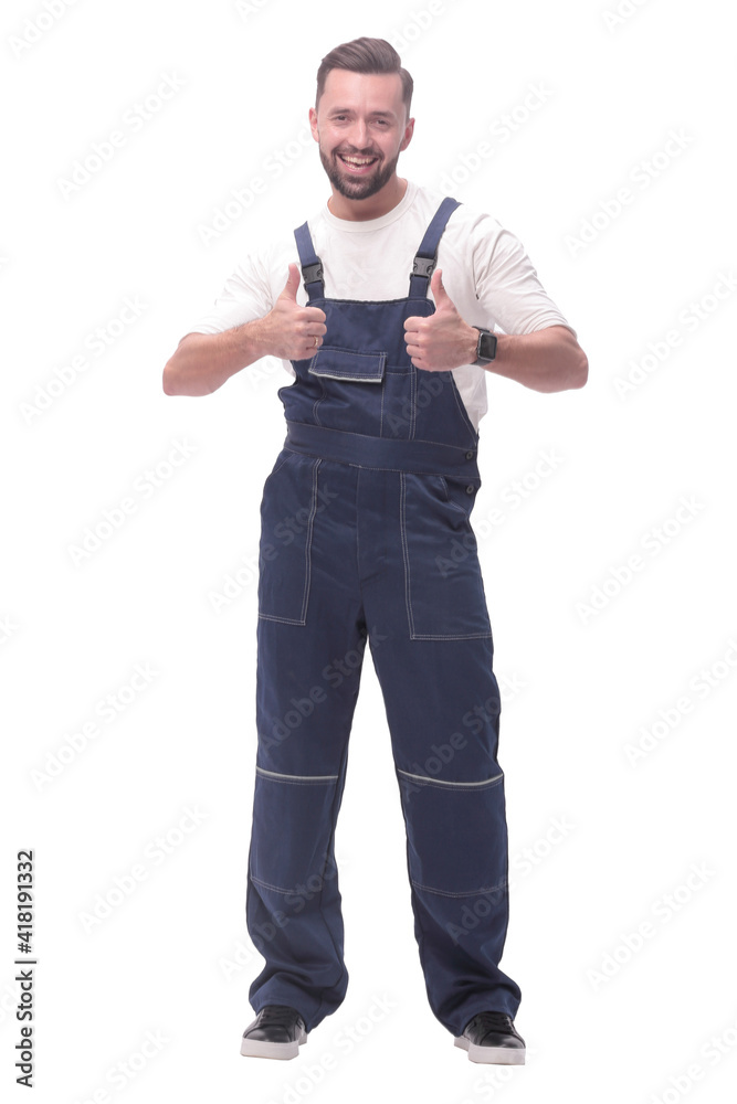 in full growth. friendly man in overalls showing thumbs up in full growth. friendly man in overalls showing thumbs up